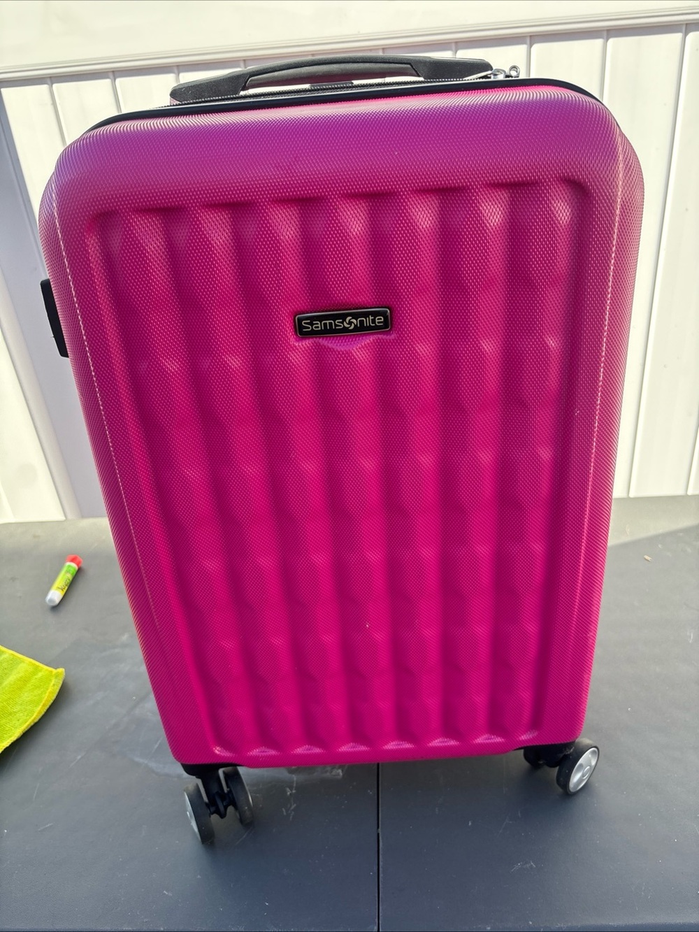 Samsonite magenta hard-shell spinner suitcase